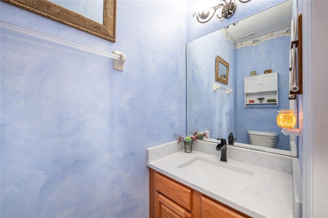 bathroom featuring vanity and toilet