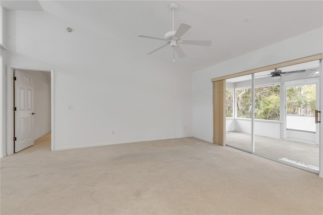 carpeted spare room with ceiling fan and lofted ceiling