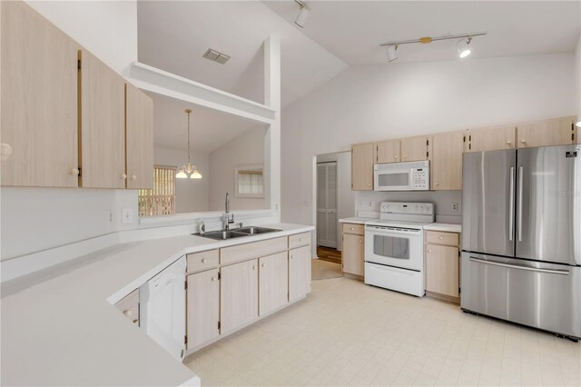 kitchen with sink, decorative light fixtures, high vaulted ceiling, light brown cabinets, and white appliances