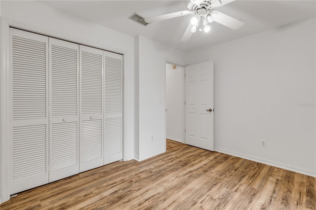 unfurnished bedroom with light hardwood / wood-style floors, a closet, and ceiling fan