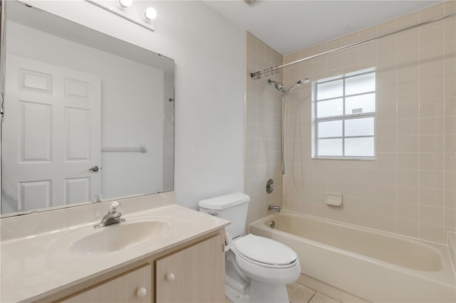 full bathroom with vanity, tile patterned flooring, toilet, and tiled shower / bath