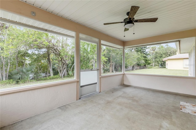 unfurnished sunroom featuring ceiling fan