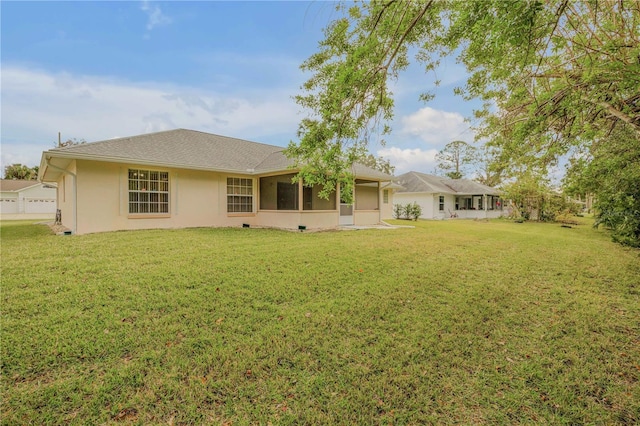 rear view of house with a yard