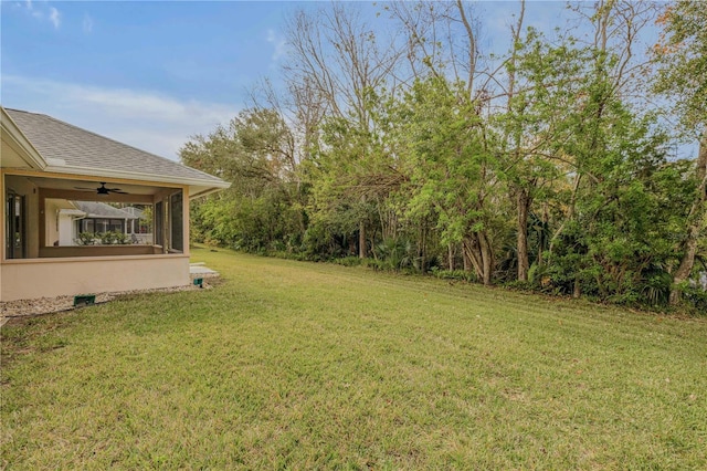 view of yard with ceiling fan