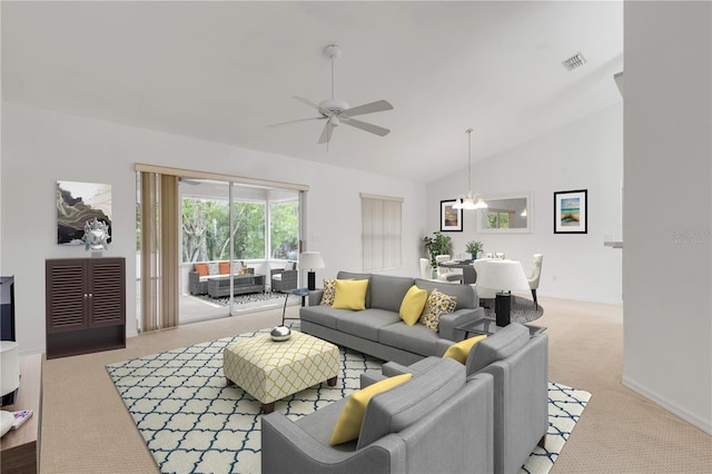 carpeted living room with lofted ceiling and ceiling fan with notable chandelier