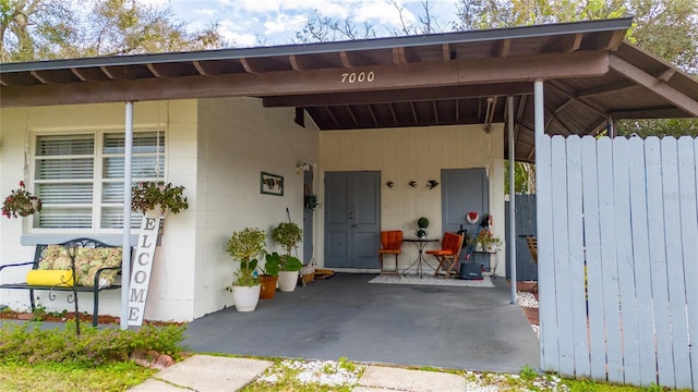 property entrance featuring a carport