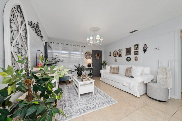 tiled living room with an inviting chandelier