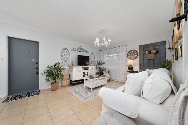 tiled living room with a notable chandelier and a textured ceiling