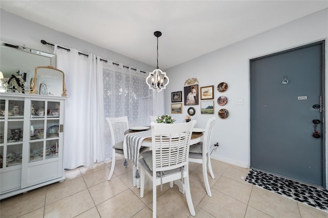 dining room featuring light tile patterned flooring and an inviting chandelier