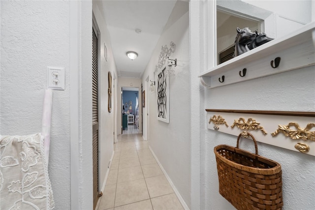 corridor featuring light tile patterned floors