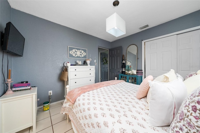 tiled bedroom with a closet