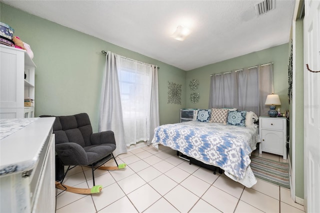 bedroom featuring light tile patterned floors