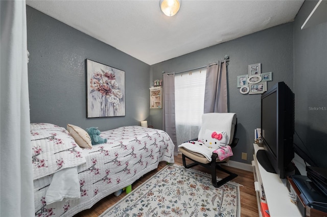 bedroom featuring hardwood / wood-style flooring