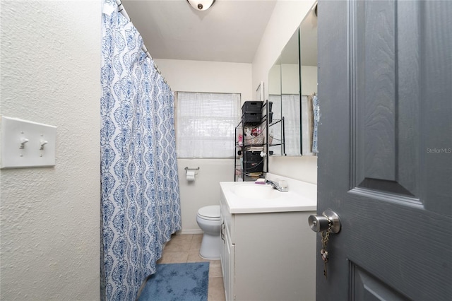 bathroom with tile patterned floors, vanity, and toilet