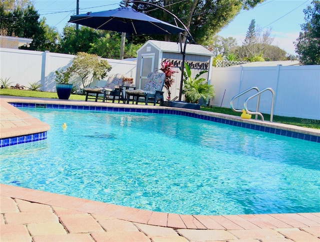 view of swimming pool featuring a shed