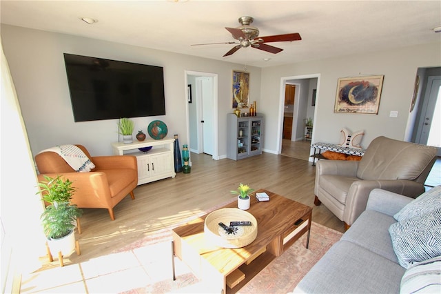 living room with ceiling fan and light wood-type flooring