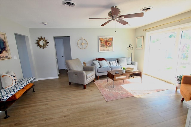 living room with ceiling fan and light wood-type flooring