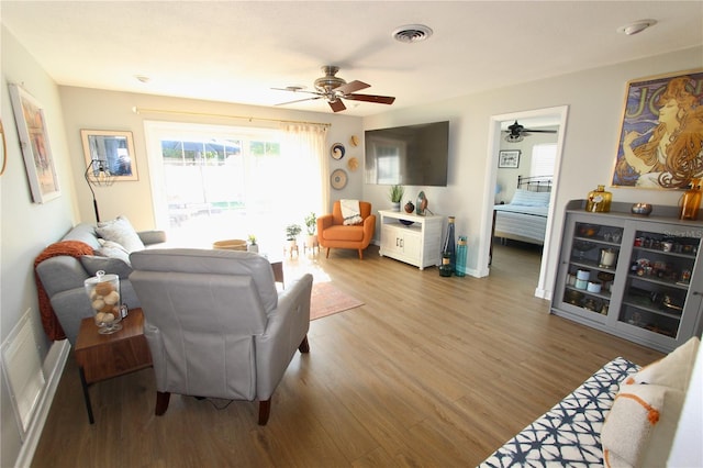 living room with hardwood / wood-style floors and ceiling fan