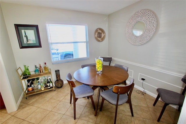 dining space featuring light tile patterned flooring