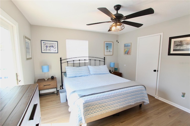 bedroom featuring multiple windows, light wood-type flooring, and ceiling fan