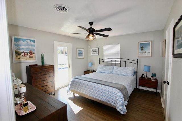 bedroom with dark hardwood / wood-style floors and ceiling fan