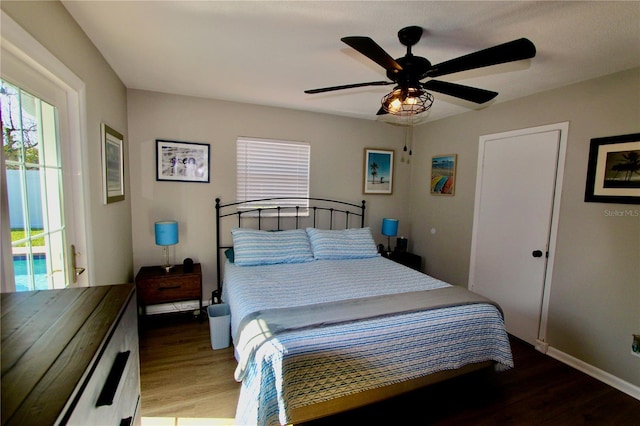 bedroom with ceiling fan and dark hardwood / wood-style floors