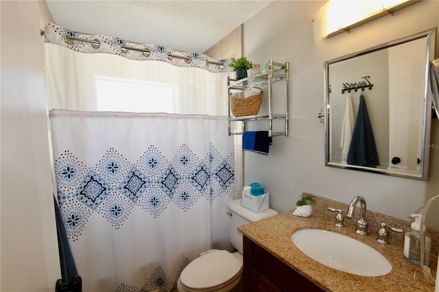 bathroom featuring a shower with curtain, vanity, and toilet