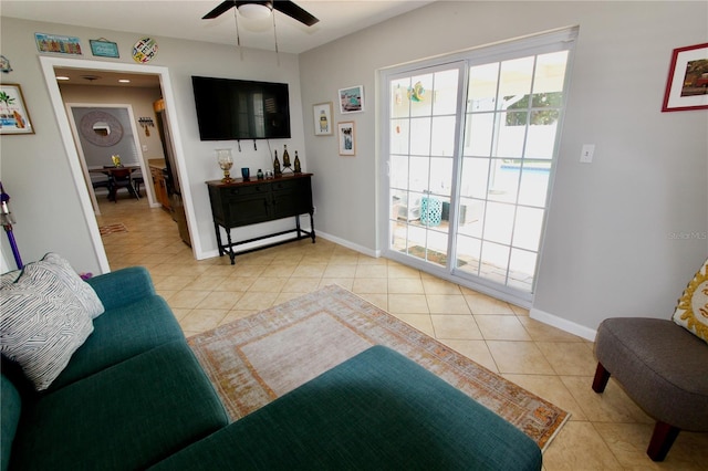 tiled living room with ceiling fan