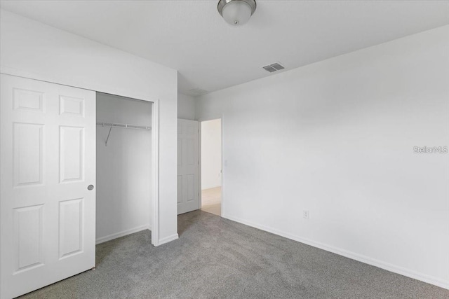 unfurnished bedroom with a closet and carpet