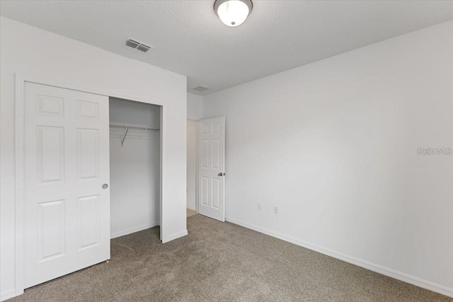 unfurnished bedroom with a closet and carpet floors