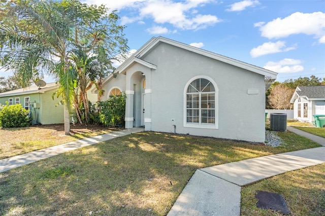 view of front of property with a front yard and central air condition unit