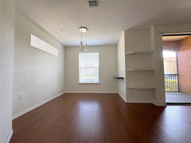 interior space with dark wood-type flooring and a textured ceiling