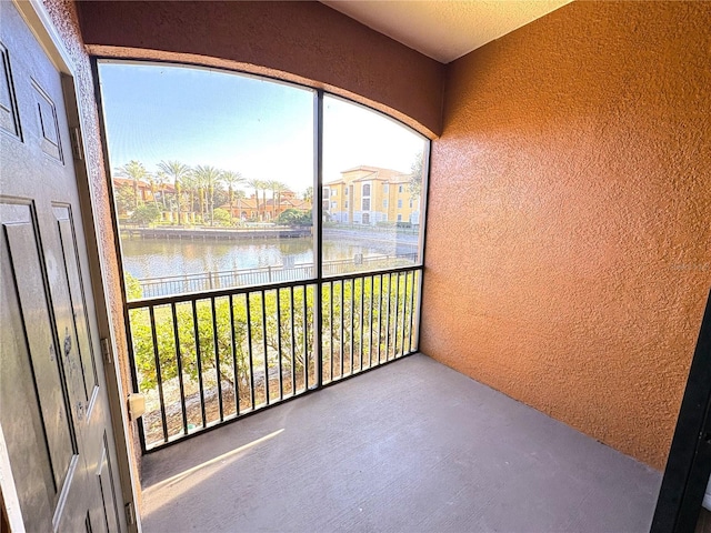 unfurnished sunroom with a water view