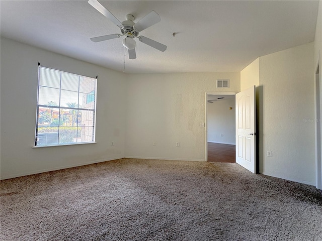 carpeted empty room featuring ceiling fan