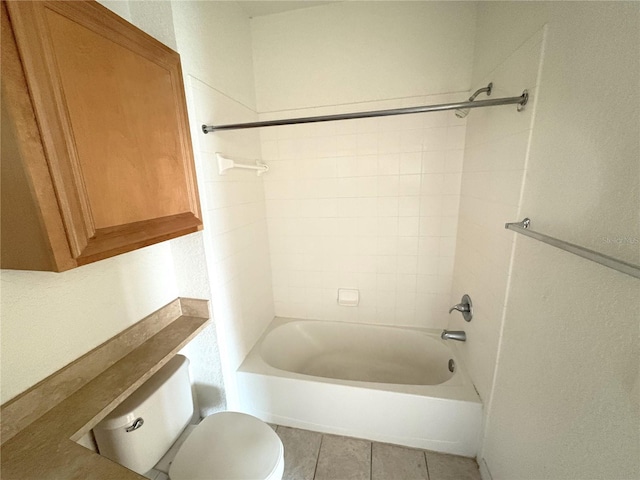 bathroom with toilet, tile patterned floors, and  shower combination