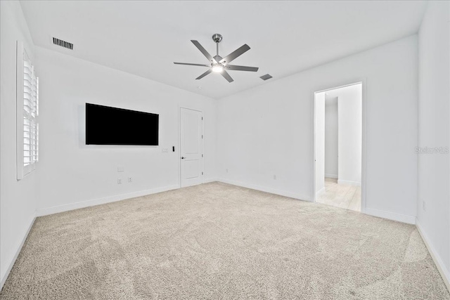 carpeted spare room featuring ceiling fan