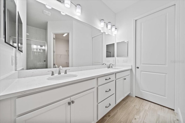 bathroom with vanity and a shower with shower door