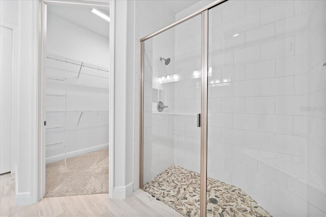 bathroom with walk in shower and hardwood / wood-style flooring