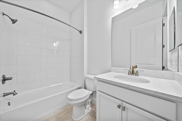 full bathroom with vanity, toilet, tiled shower / bath combo, and hardwood / wood-style floors