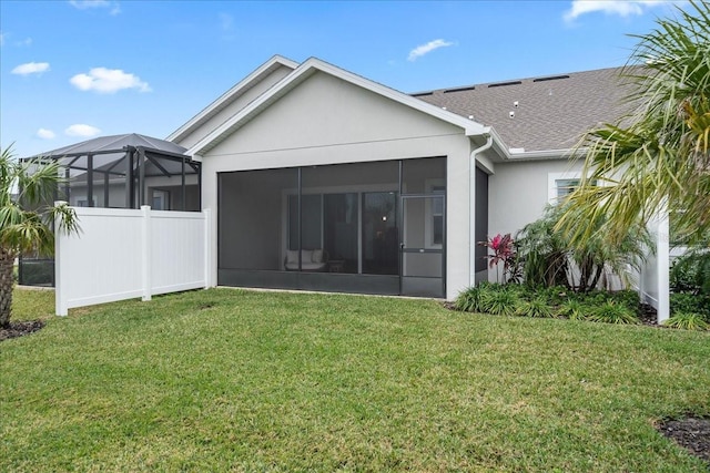 back of house with a lawn