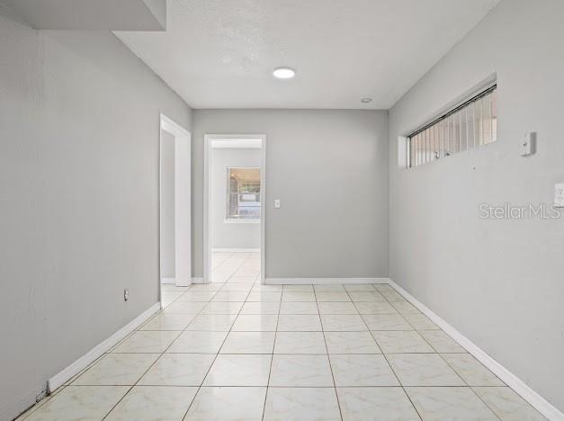 hall with light tile patterned flooring