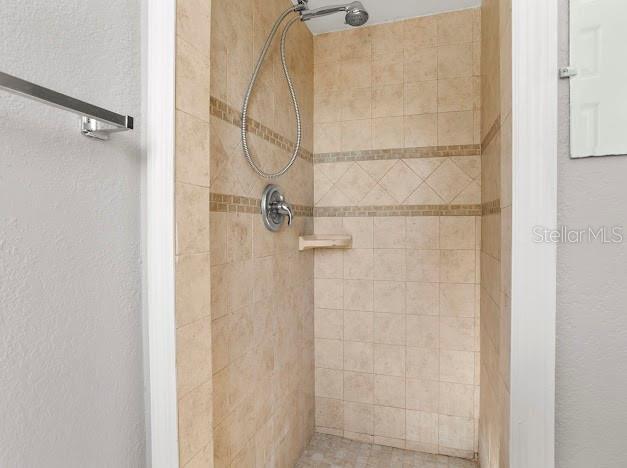 bathroom with a tile shower