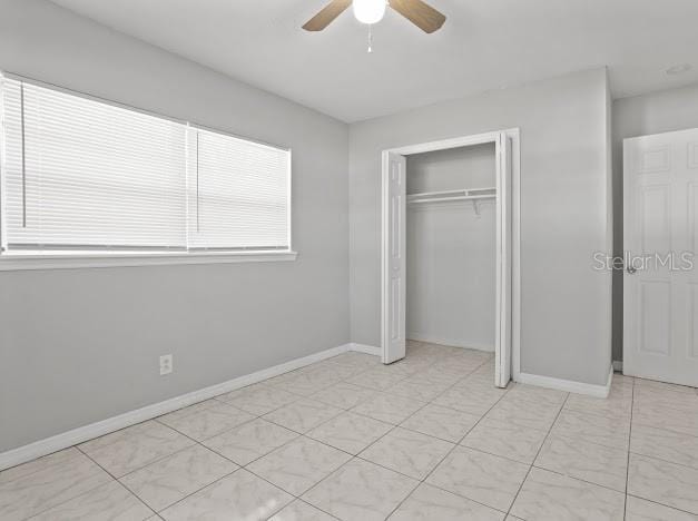 unfurnished bedroom with a closet and ceiling fan