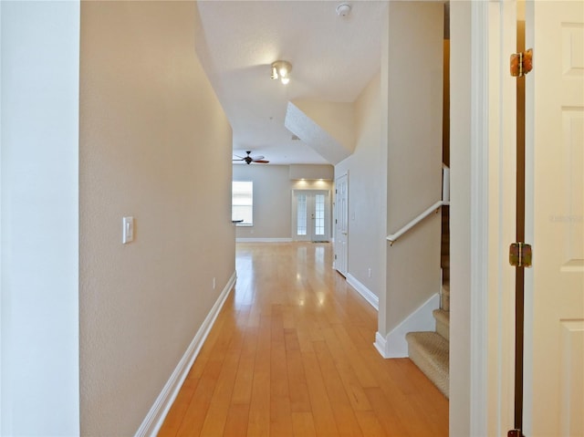 corridor with light hardwood / wood-style floors