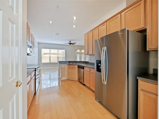 kitchen featuring light brown cabinets, stainless steel appliances, sink, kitchen peninsula, and ceiling fan