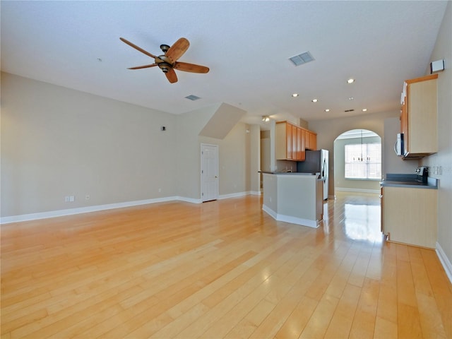 kitchen featuring light wood-type flooring, ceiling fan, stainless steel appliances, and light brown cabinets