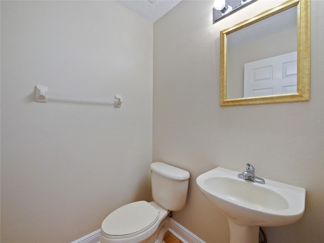 bathroom featuring toilet and sink