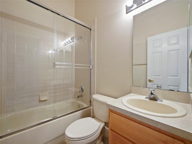 full bathroom with toilet, vanity, and shower / bath combination with glass door