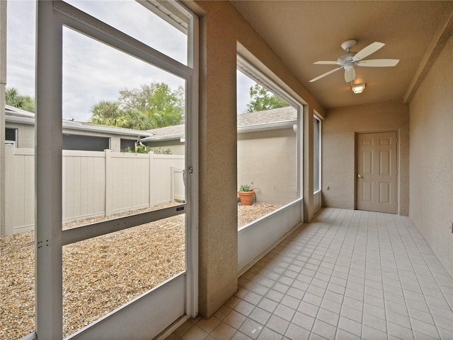 sunroom featuring ceiling fan