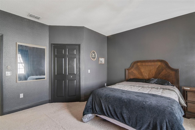 carpeted bedroom with a closet